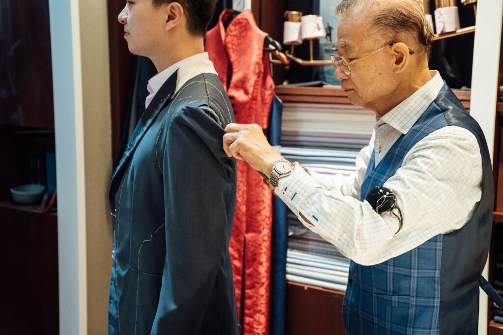The shop salesperson measuring a customer's shoulder length